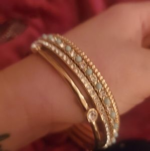 Stack of 4 bangle bracelets. Gold, mint and cubic zirconia gems.